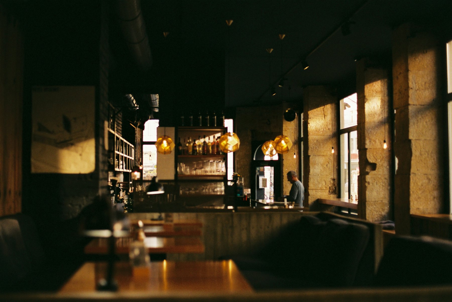 Softly lit cafe interior with wooden tables and chairs in the evening