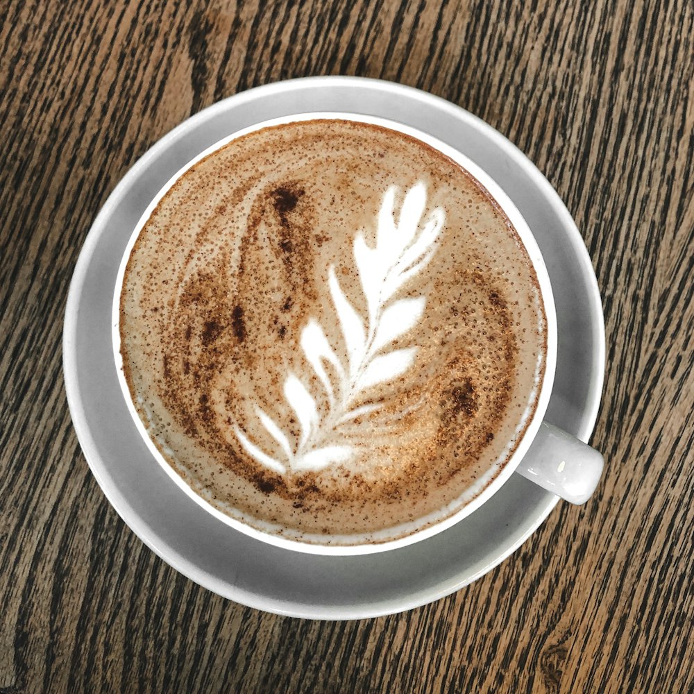 Flat white with rosetta latte art in a white cup, seen from above