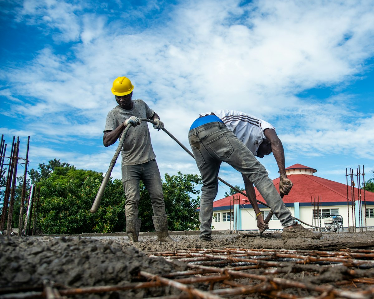 Crew pouring concrete on a sunny day
