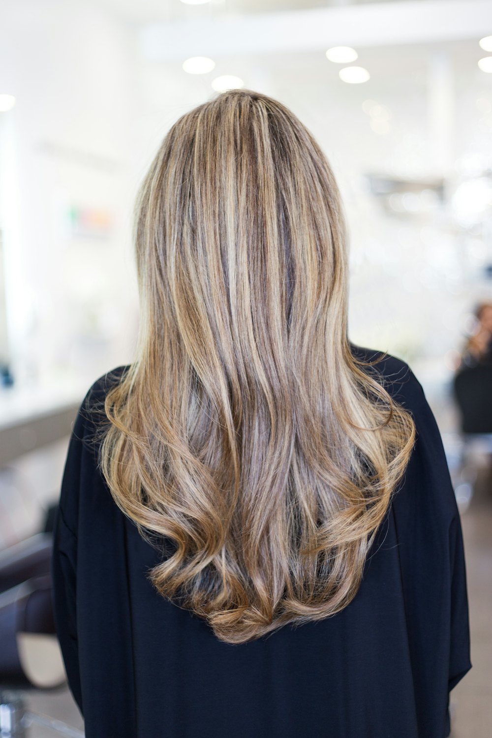 Long blonde balayage hair colour seen from behind