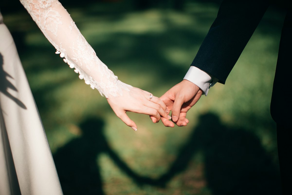 Couple holding hands, close-up